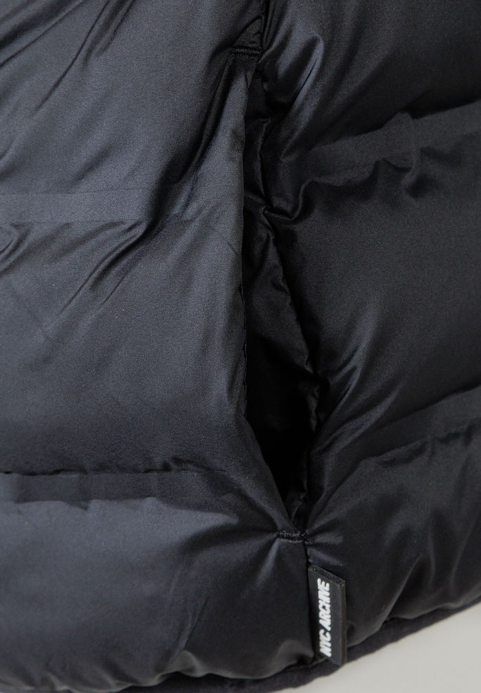 Detail of a boys' lightweight black jacket with dual side pockets.
