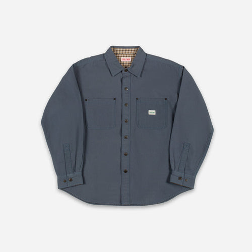 A dark slate blue long-sleeve button-up shirt with two chest pockets, laid flat against a light gray background.