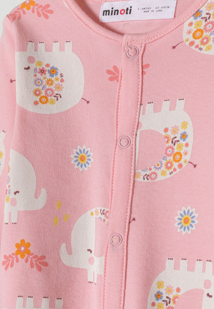 Detail of a pink long sleeve sleepsuit with elephant print and press studs.