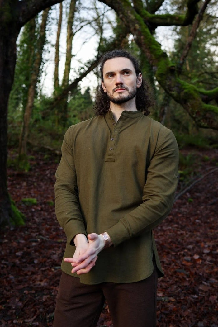 Men’s forest green grandad collar shirt with button placket in a woodland setting