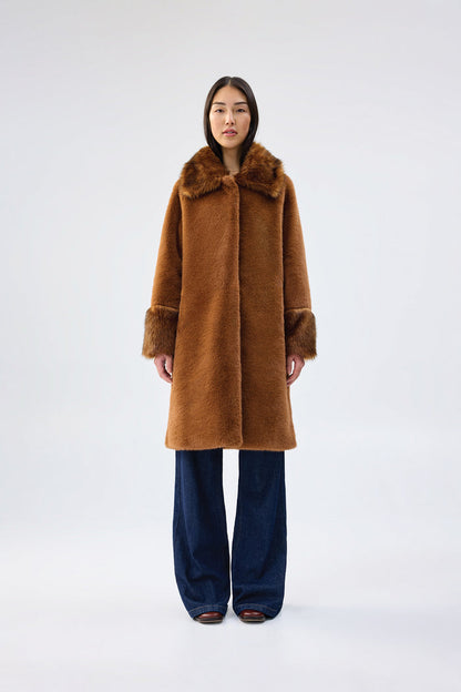 Brown faux fur coat with contrasting darker brown collar and cuffs, mid-length relaxed fit, worn over dark wash wide-leg jeans, front view