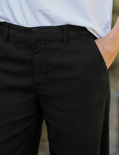 Person wearing black pants with a blurred background